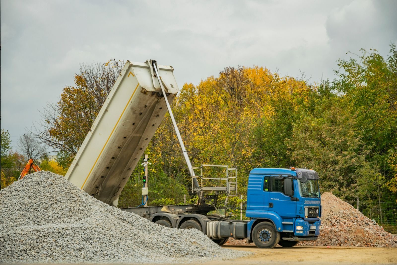 Dump truck delivering gravel for a driveway