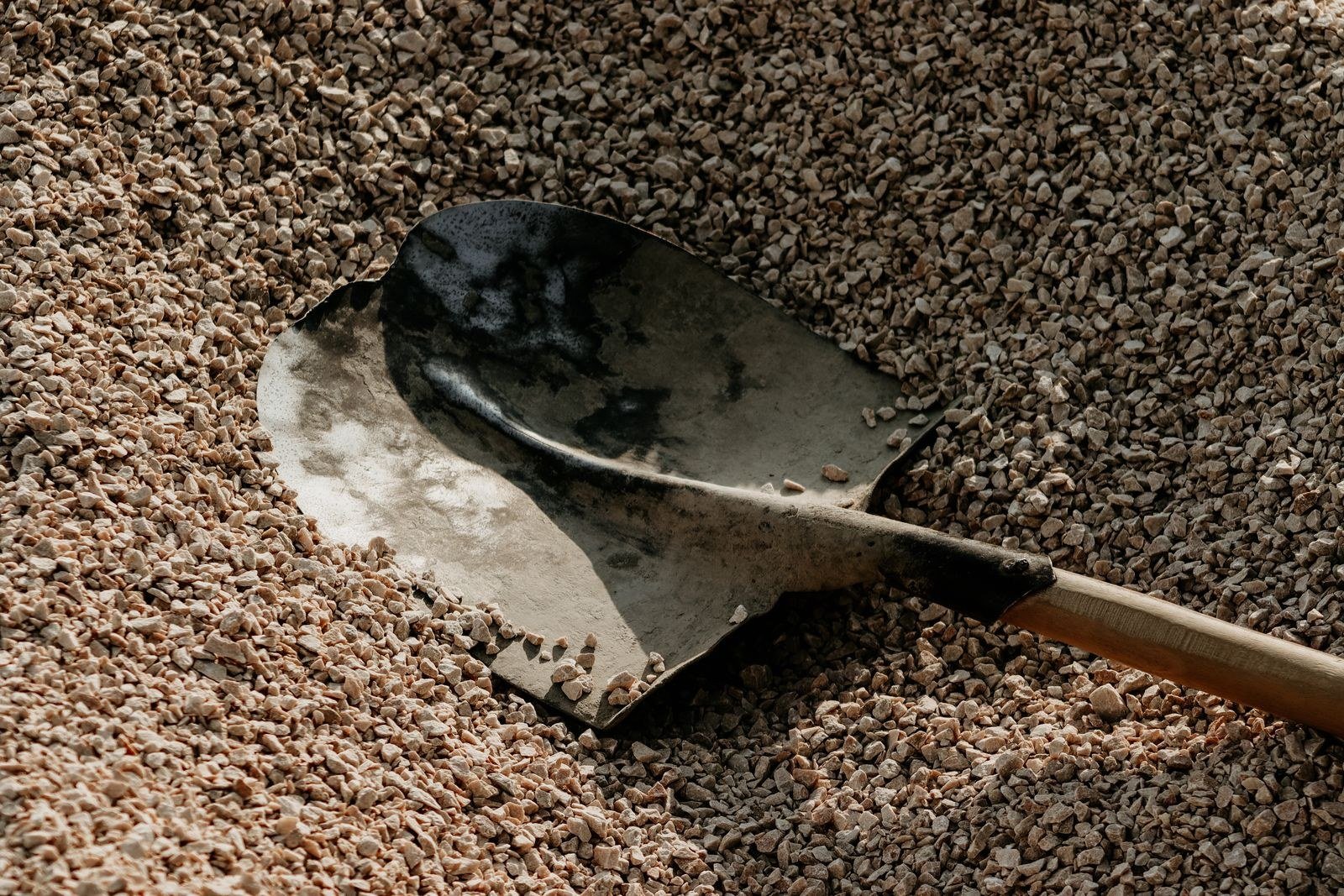 shovel resting on a pile of gravel